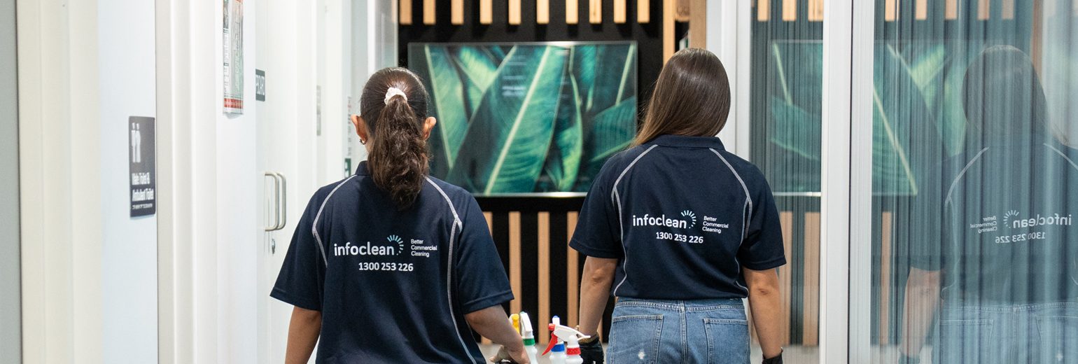 Infoclean team walking through an office hallway